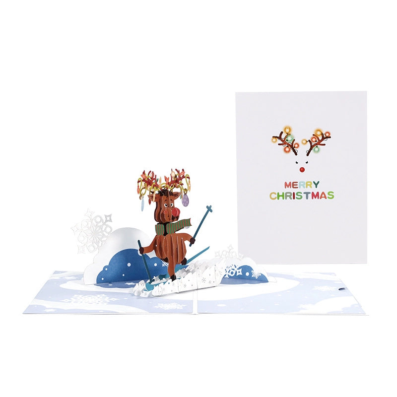 Two Skiing Reindeer 3D cards opened side by side showing intricate paper engineering and snowflake details.