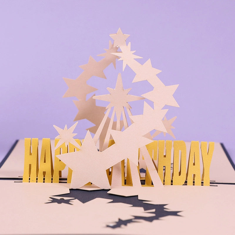 Detailed front view of the golden "Happy Birthday" letters and layered paper stars inside the 3D greeting card.