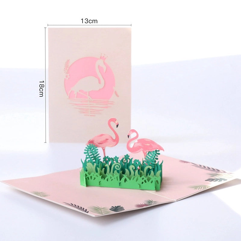 Dimensions of the flamingo pop-up card showing 18cm height and 13cm width, displaying the 3D paper art structure and laser-cut front cover.