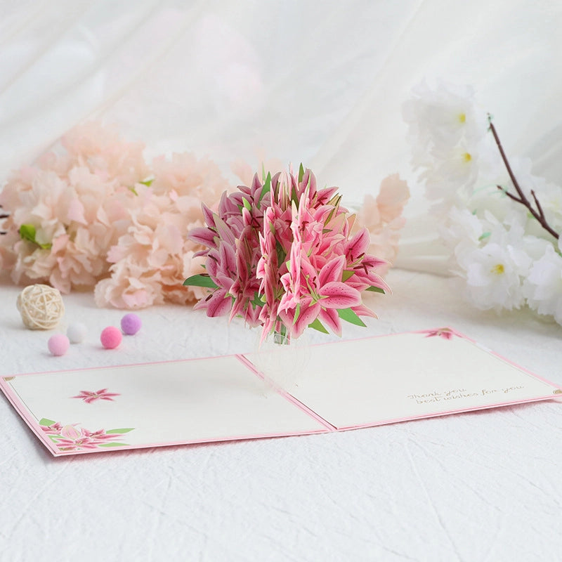 Side view of pink lily flower pop-up card highlighting detailed paper petals and green leaves

