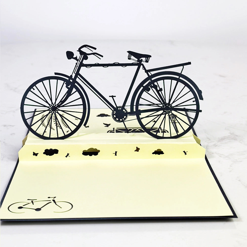 Vintage bicycle 3D pop-up card standing open on a table